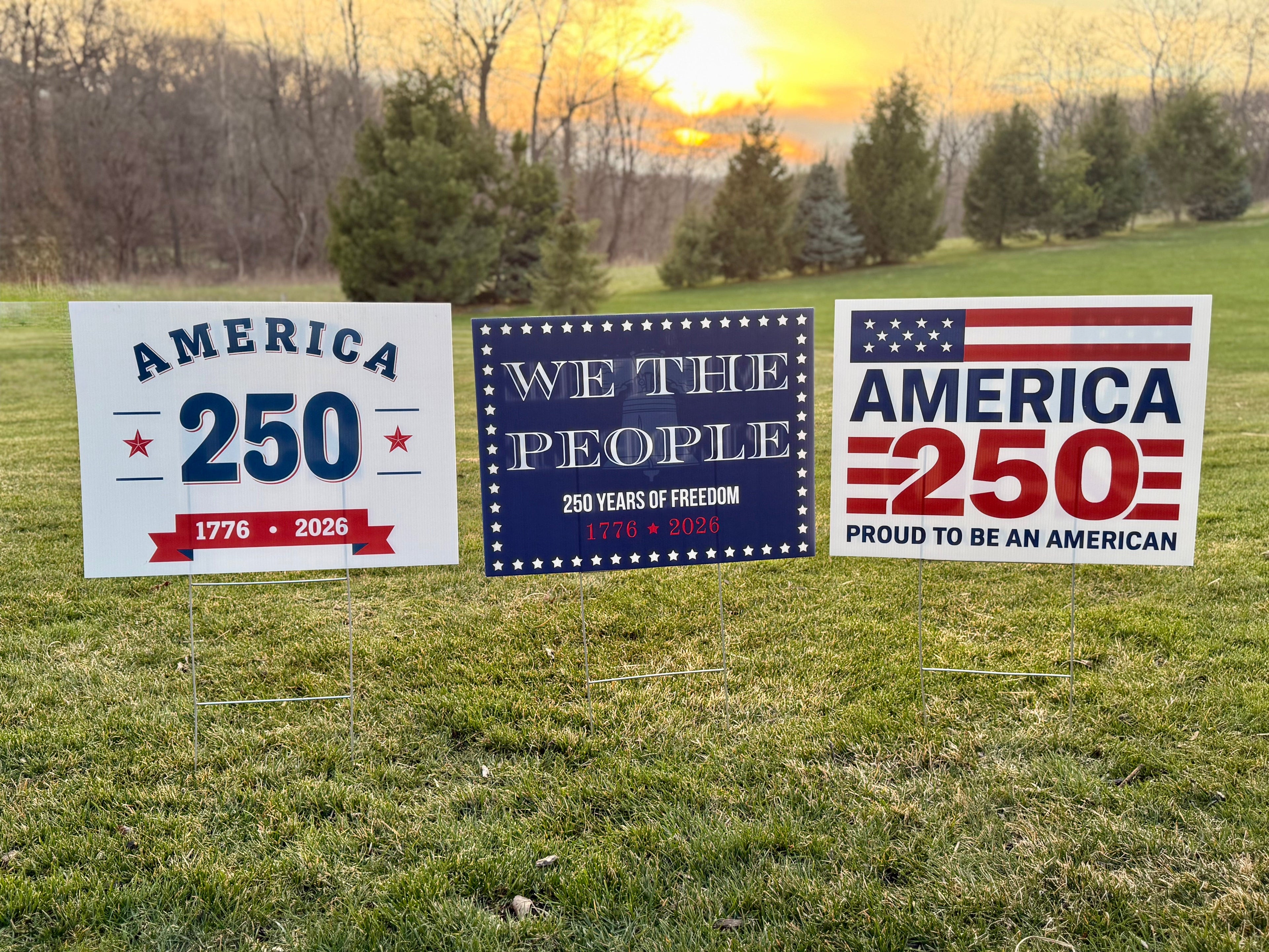 America 250, We The People, Proud to be American yard sign at sunset